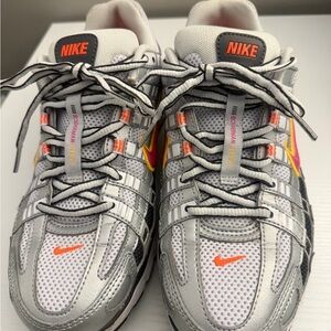 Nike women’s  Silver, White, and Orange Sneakers
